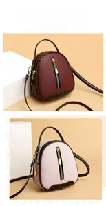 Detail of trendy bucket bag with pebbled leather texture and golden front zipper