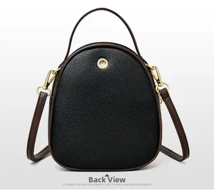 Back view of a black pebble grain bucket bag with brown handles and gold hardware