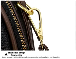 Detail of premium gold hardware and lobster clasp on black lychee grain leather handbag
