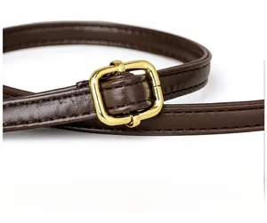 Detail view of premium dark brown leather shoulder strap with golden metal adjustment buckle