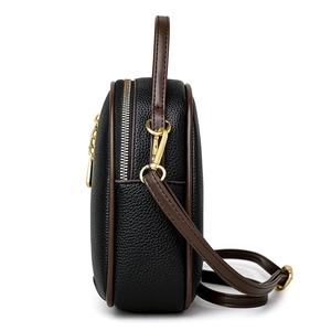 Chic black litchi leather bucket bag with contrast brown trim and gold metal hardware