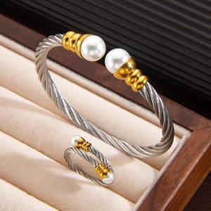 Detail of twisted cable jewelry set with 18k gold accents and white pearls in a velvet box