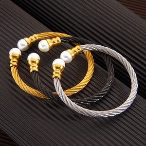 Adjustable twisted cable bracelets with pearls in gold, black, and silver finishes
