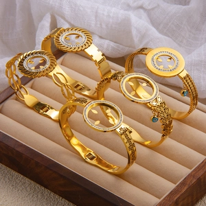 Set of five 18k gold plated bracelets featuring evil eye charms and Greek key patterns