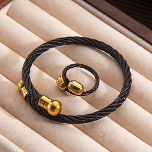 Twisted steel cable jewelry set with gold ball accents featuring a bracelet and matching ring