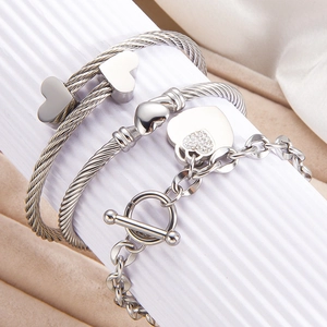 Three-piece silver stainless steel jewelry set with heart charms and twisted cable bangles