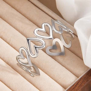 Minimalist silver-toned cutout heart-shaped ring in polished stainless steel