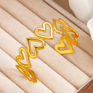 Elegant 18k gold plated hollow heart cuff bracelet on beige velvet jewelry box display