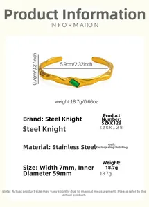 Detailed view of irregular 18k gold plated bangle with rectangular green emerald gemstone