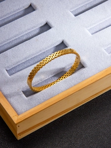 Detailed close-up of a 18k gold plated stainless steel mesh link bracelet on display