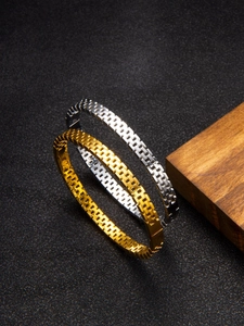 Detailed view of gold and silver stainless steel bangles with chain link texture