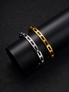 Detailed view of dual-track hollow bracelets in gold and silver finish with inlaid zircons