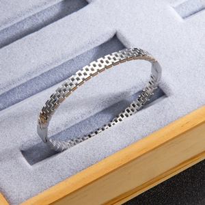 Silver mesh titanium steel bracelet with chain link texture on a luxury jewelry tray