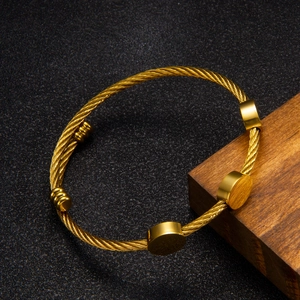 Polished 18k gold plated twisted rope bangle featuring circular charms and ribbed tips