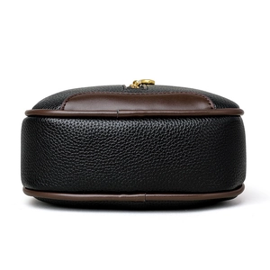 Classic black litchi grain leather bucket bag with brown trim and golden zipper
