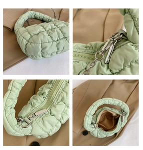 Detail view showing quilted texture, silver hardware and interior of green cloud bag