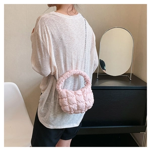 Detailed close-up of pink quilted cloud bag with diamond stitching and silver chain strap