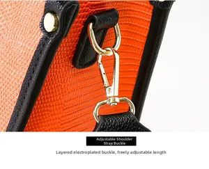 Détail de la boucle de sangle réglable plaquée or sur sac en cuir orange à motif animal