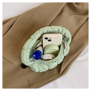 Top view of a quilted cloud bag in light green showing its interior storage capacity