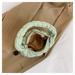 Top view of green quilted cloud bag interior with zip closure and plush texture