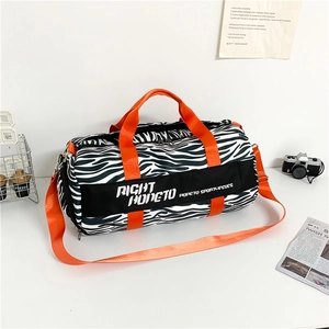 Zebra print large travel duffel bag with bright orange handles and shoulder straps