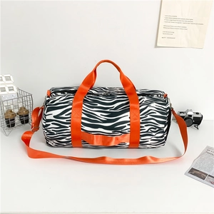 Zebra print cylinder travel bag with bright orange straps for sports or weekend trips
