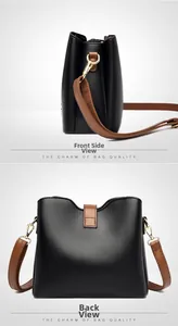 Détails du sac seau noir en cuir grainé avec bandoulière marron et boucles dorées
