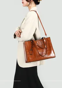 Brown crocodile pattern tote bag shown from side profile for size and scale reference