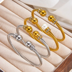 Détail de bracelets torsadés avec accents de cristaux et perles en or et argent