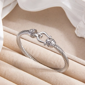 Polished silver cable twist bracelet with horseshoe buckle and sparkling zircon accents