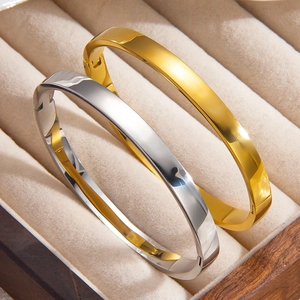 Polished gold and silver stainless steel hinged bangles in a premium jewelry display box