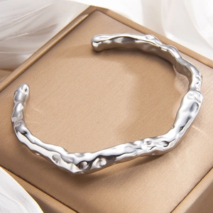 Irregular C-shaped open bangle with liquid metal lava texture in high-shine silver finish
