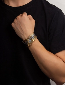 Macro detail of men's twisted cable rope bracelets in gold and gunmetal steel finish