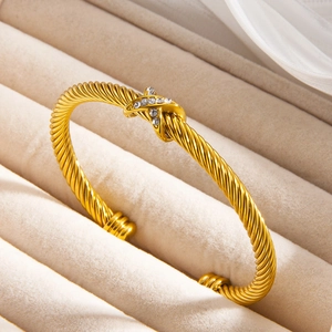 Gold twist rope cuff bracelet with crisscross knot and sparkling crystal pavé setting