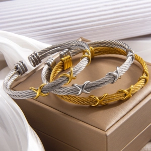 Twisted cable wire bangles in gold and silver with X-shaped metal cross accents