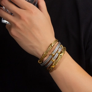 Adjustable twisted cable bracelets with gold X-link accent in two-tone metal finish