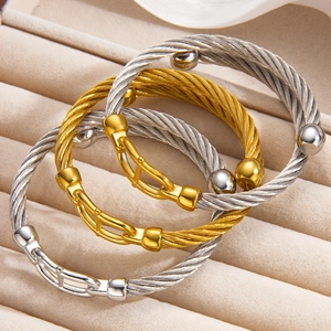 Detail of gold and silver cable twist bangles in a velvet jewelry display box