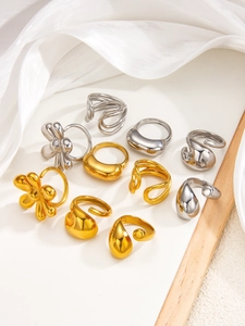 Detailed close-up of 18k gold and silver plated flower rings with smooth mirror polish