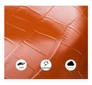 Macro view of soft breathable orange crocodile embossed leather texture on handbag