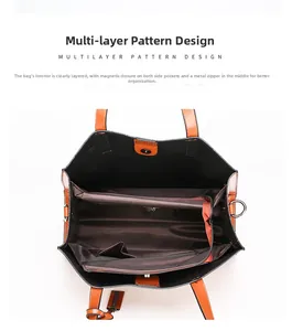 Top view of brown leather tote showing a three-compartment interior with metal zipper and magnetic snaps