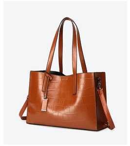 Brown crocodile embossed tote bag with dual straps and adjustable shoulder belt