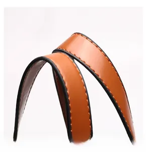 Close-up of the smooth brown leather handle with meticulous stitching on the handbag