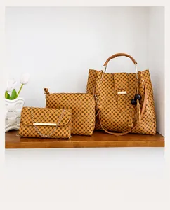 Detailed set of three golden-brown geometric tote, clutch, and chain crossbody bags