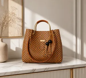 Detail of checkered tote bag with metal handle and decorative tassel on a model