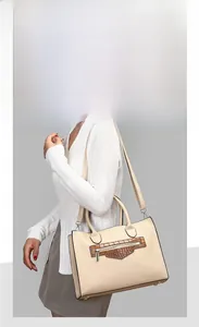 Detail of lychee pattern leather handbag with brown crocodile texture and gold hardware