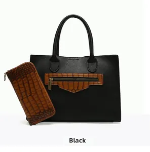 Detail of black pebbled leather tote bag and brown crocodile pattern zipper wallet set