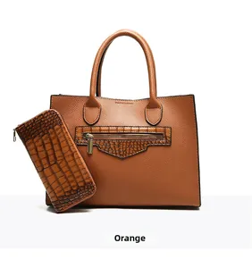 Detail of orange tote and wallet set showing lychee grain and crocodile texture