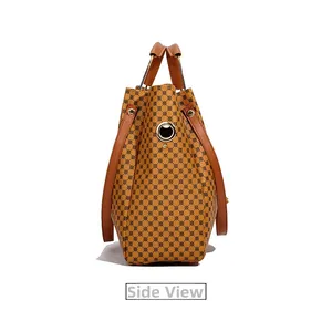 Side view of large tote bag featuring brown geometric pattern and leather handles