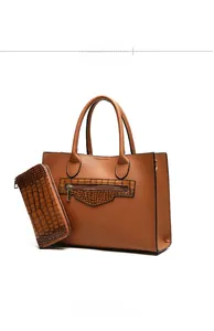 Detail view of brown pebbled leather tote set with matching zip wallet and side profile