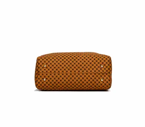 Detail view of brown geometric textured bag bottom with four protective gold metal studs